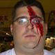 Simple horrifying face paint bloody scar on man's face.