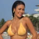 Pretty as a peach...Angies models this peach color bikini that caresses her curvaceous figure splendidly.The triangle top has adjustable gold metallic ties for a comfortable fit.