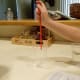 The greater pressure of air under the straw holds the liquid inside it.