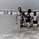 My dad, mother and brother John in the water.