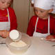 Adding the cream, vanilla, and powdered sugar.