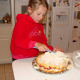 Grace spreads the whipped cream.