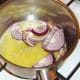 Red onion slices are added to melted butter