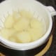 Potatoes are drained through a colander
