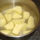 Potato is peeled, chopped and added to cold, salted water