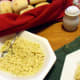 Sauteed corn and yeast roll, an addition to the meal.