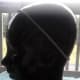 Ceramic head modeling an elastic headband with rubber grips.