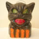 Amazingly spooky black cat with evil green eyes and vicious red teeth.