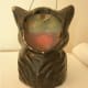 Inside the paper mache cat, a piece of paper would be taped that had the eyes and mouth design printed on it.