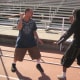Jaime, wielding a stick, and Glenn face off.