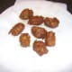 Pakora spiced chicken and vegetable fritters are drained on kitchen paper