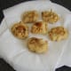 Spicy chicken and potato fritters are drained on kitchen paper