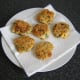 Chicken, sweetcorn and bell pepper fritters are drained on kitchen paper