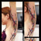 Underarm paint splash tattoo