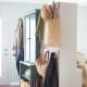 Smart options. Reverse 2 cabinets to create space in both rooms as it also adds a divider. Add hooks to the back for hanging articles.