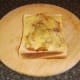 Melted cheese is seasoned with black pepper