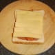 Sliced cheese tops Spam and peppers
