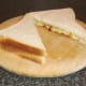 Spicy Spam, peppers and cheese sandwich is sliced to serve