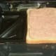 Starting to build toastie with Spam on bread