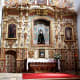 The ornate interior of the Church of Nuestra Senora de Regla in Pajara. Behind the altar is the figure of the Madonna. The main entrance is shown elsewhere on this page