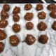 The truffles placed on a cool surface e.g. marble as soon as they are dipped in the melted chocolate; and then marble board with the truffles is placed in the fridge until the chocolate sets.