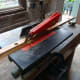 Trimming a piece of pine salvaged from a redundant shoe rack, and being recycled to fix a wood strip between the wardrobe and cupboard doors for the cupboard door bolts