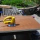 Using a jig saw to cut the curve in the sheets of plywood