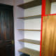 The old veneered chipboard shelving emptied, ready for dismantling and replacing