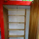 The new book case, made from pine floorboards (6 inches depth), in a more accessible location. On the back wall, the outline of the original pigeonhole shelves, that were previously removed because they were too deep