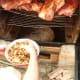Adding the soaked woodchips to the pan
