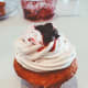 Lemon cupcakes with vanilla frosting and fresh blueberry jam on top