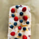 Lemon bread topped with sugar glaze, fresh blueberries, and raspberries