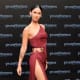 Megan Fox in a revealing dress with a hip high slit up the side wearing platform high heels