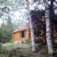 Partial view of front of Hibbard's log cabin in Ely, Minnesota
