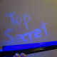 The message written in petroleum jelly glows under a blacklight.