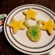 Use glitter decorating gel to create the face on the alien cookies.