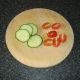 Tomato and cucumber form the garnish for the pasta along with some green salad leaves