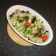 Pasta and parsley are carefully stirred through the roasted vegetables