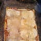 Completed layer of cheese, using shredded cheeses to fill in gaps between mozzarella slices.