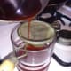 Once you have allowed your tea to steep, you are ready to strain your tea. You can use a small sifter like shown. Or cheesecloth will work as well. This is simply to remove any large pieces from your tea.