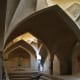 The communal pool in this Roman Bathhouse rests under vaulted arches.