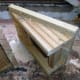Side View. Two equal sides, each triangular in shape, with the top end just over an inch shorter than of the height of the decking the ramp will be used for.