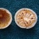 Bael fruit cut into two and flesh of one scooped out.