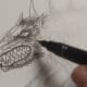 Drawing the teeth and hair around the head and other details.