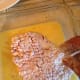 Gently transfer the cube steak to the egg mixture. Gently move it around to coat the underside with egg.