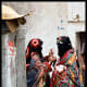 Two Yemeni females in Sana'a city while wearing the Sana'ani Sitarah with its Mughmug and Lithmah