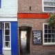 Go through the opening next to The Hole in the Wall pub