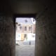 You will enter a court and to the right see the view of the minster shown above