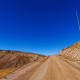 Tall sticks line the edges of Old Fall River Road to identify the sides of the road for snow plowing, near the Alpine Visitor Center at Rocky Mountain National Park in Colorado.