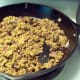 Heat onions and veggie crumbles in skillet.